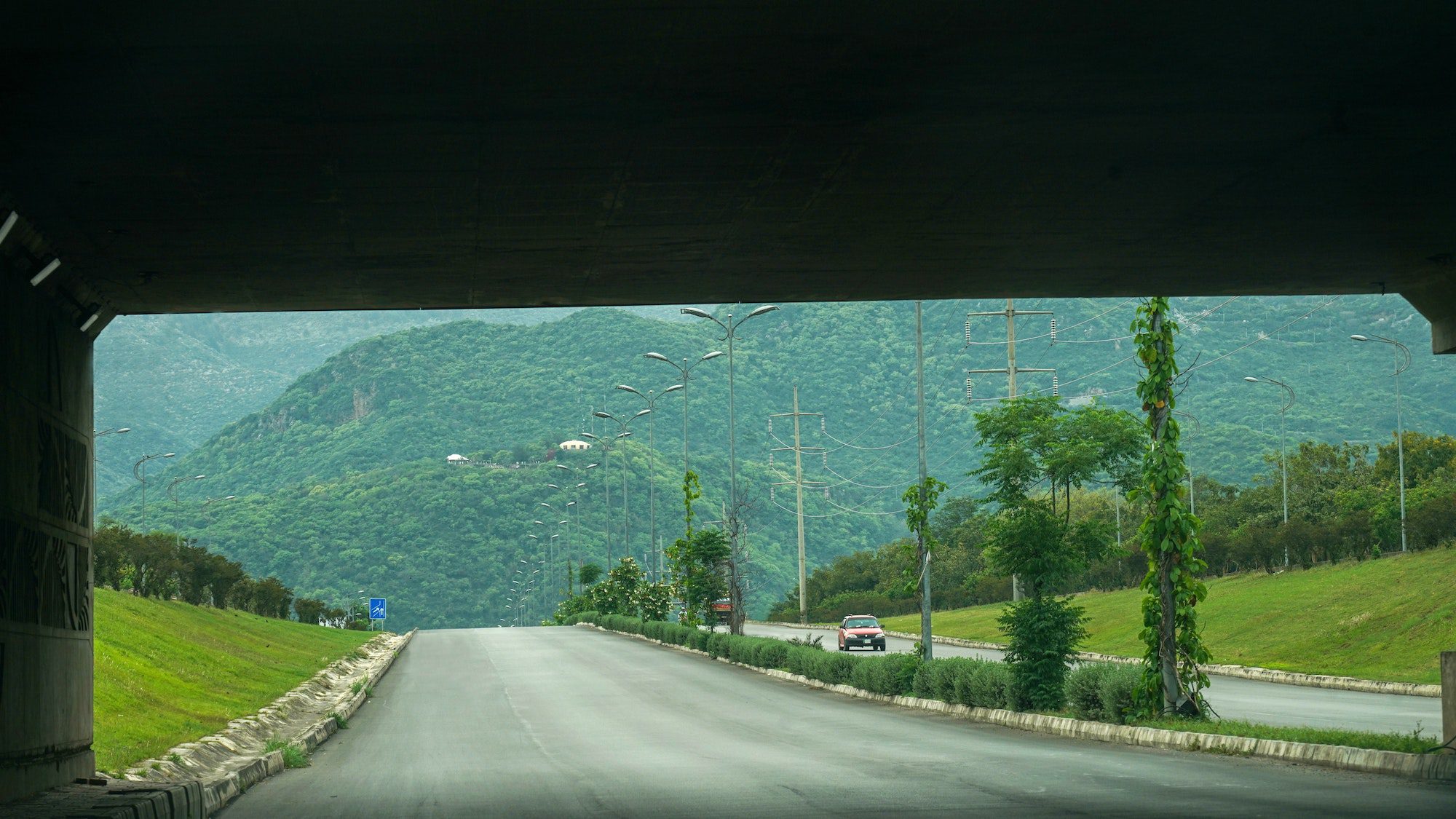 Empty highway with green mountains