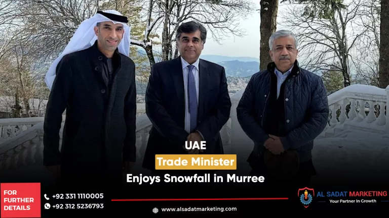 2 persons standing wiht uae minister during snowfall in murree